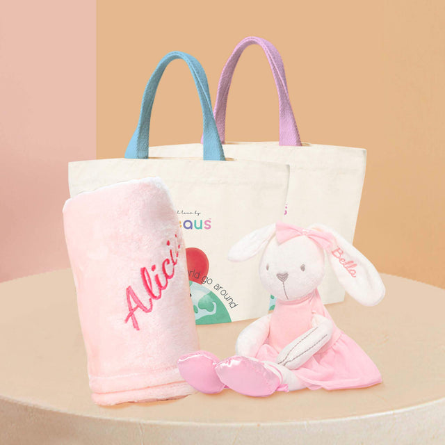 Pink Ballet Bunny Plushie displaying next to a pink fleece blanket, both with name embroidered.