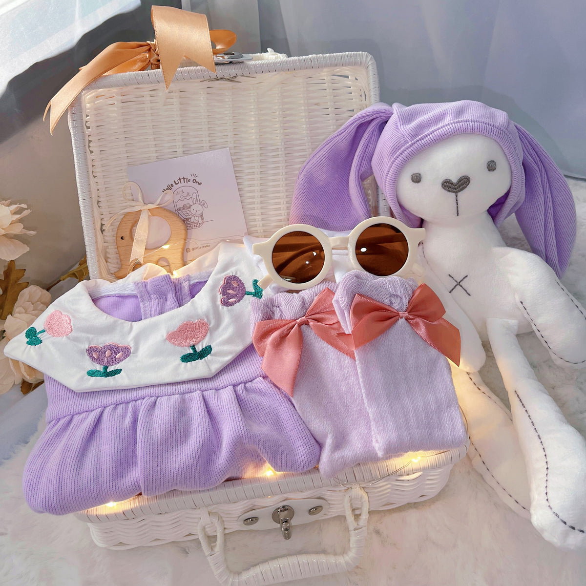 Purple Bunny premium baby gift set in a rattan basket with romper with purple bunny-ear hat