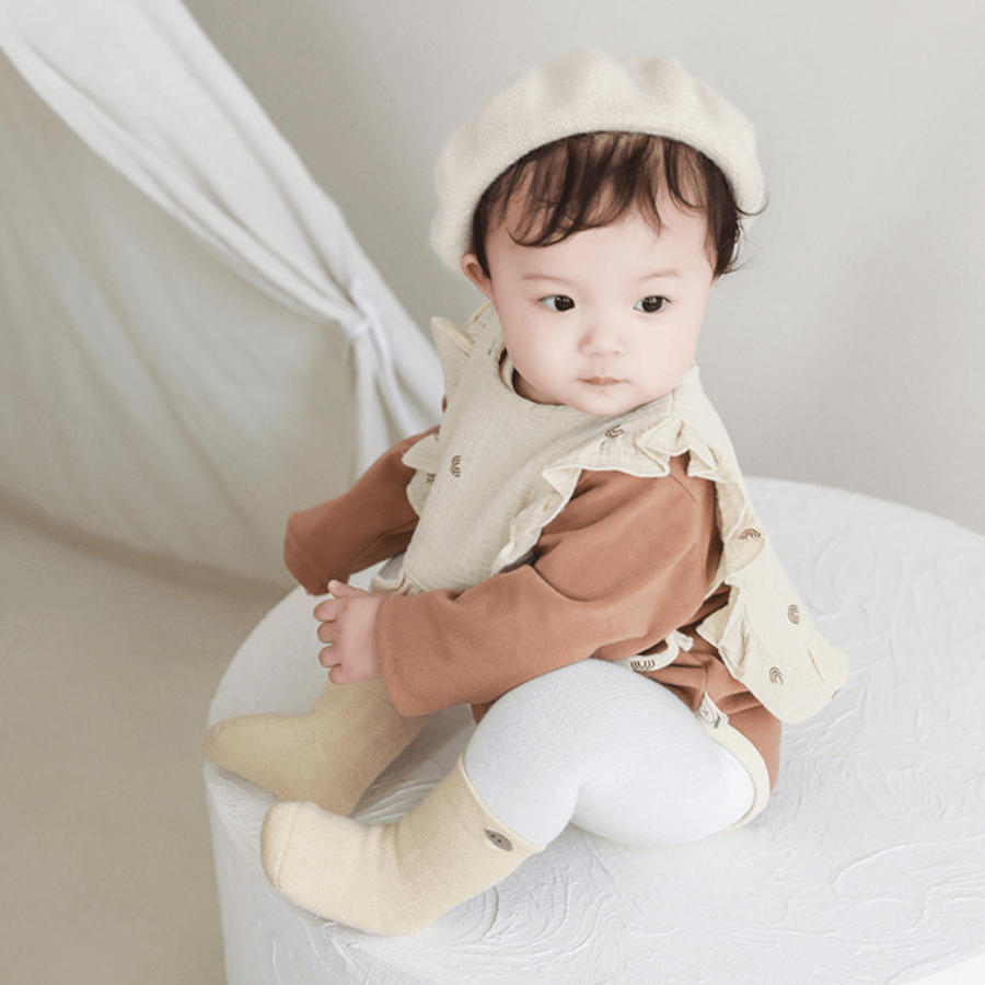 a cute chinese baby wearing a pair of baby socks