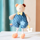 Soft bear plush teether wearing a blue outfit with a yellow bow tie and a star patch, designed to soothe teething gums.