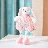 Soft bunny plush teether wearing a pink outfit with a striped pocket and scarf, designed to soothe teething gums.