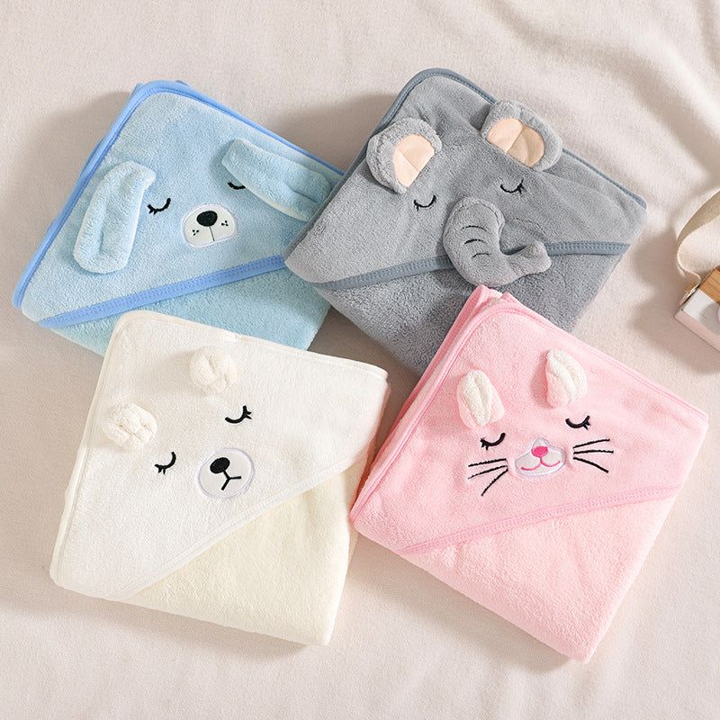 Four folded animal hooded bath towels displayed on a bed. The towels feature a blue dog, a grey elephant, a pink bunny, and a white bear.