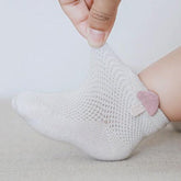 A close up of socks with colorful mushroom patterns.