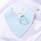 Light blue organic cotton baby bib with an embroidered bear face, featuring a snap closure for easy use.