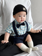 Baby wearing the Charlie Boy blue gingham shirt with bow tie and suspender shorts