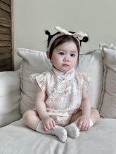 Baby wearing the Cherry Blossom pink floral cheongsam-style romper with bow headband