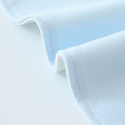 A close up of the blue cotton baby bib showing details