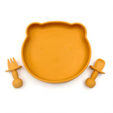 Yellow BPA-free silicone plate shaped like a bear’s face, accompanied by matching fork and spoon, designed for babies.