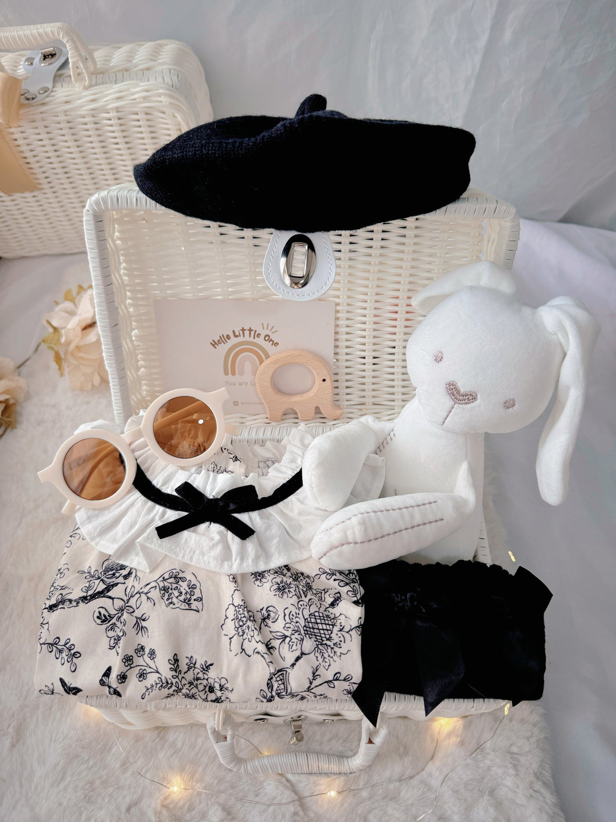 French Blossom premium baby gift set in a rattan basket with floral romper with ruffled collar and black beret