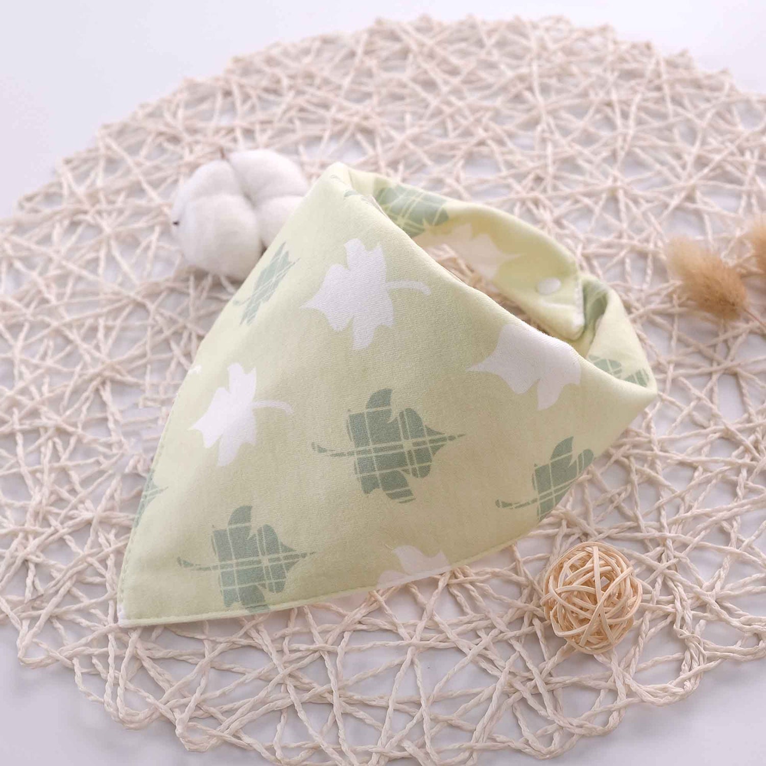 cotton green leaf bib display on a placemat