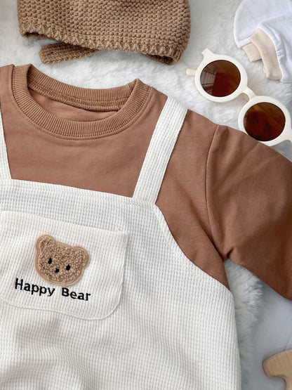 Happy Bear baby outfit flat lay – bear overall romper with bear-ear knit hat