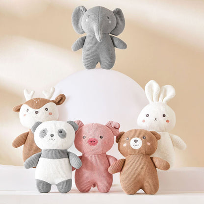 A group of stuffed animals are crowded together on a wooden shelf. The stuffed animals include a rabbit, a bear, a deer, an elephant, and a pig. They are all different colors and sizes.