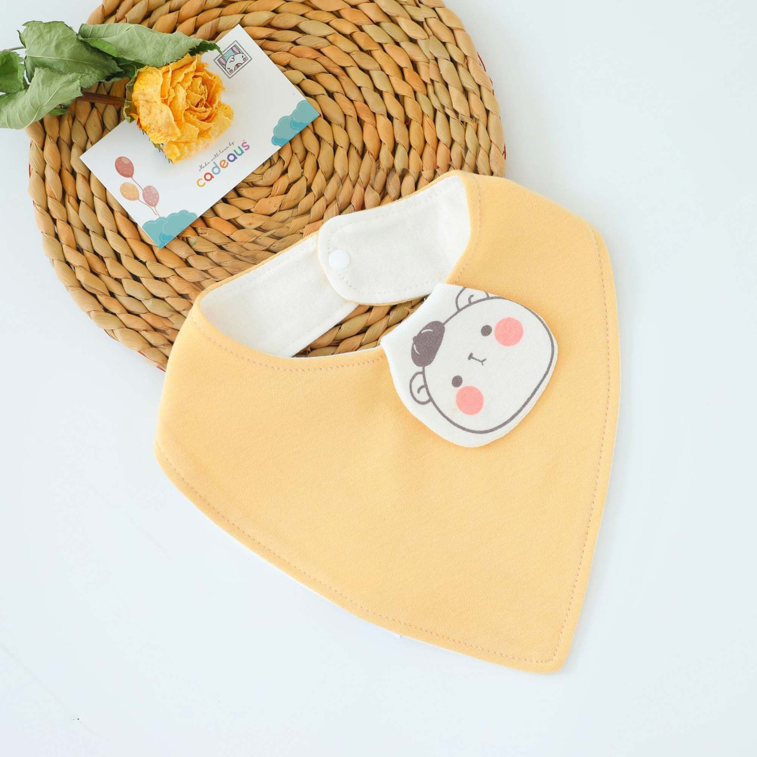 A yellow bear design baby bib with Cadeaus gift card