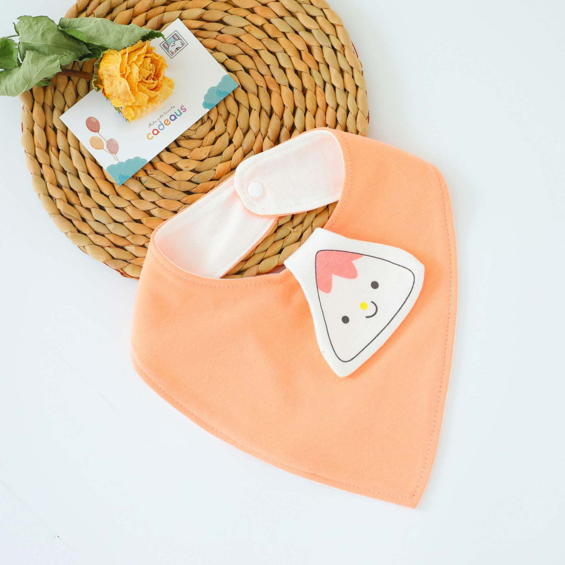A peach sushi design baby bib with Cadeaus gift card