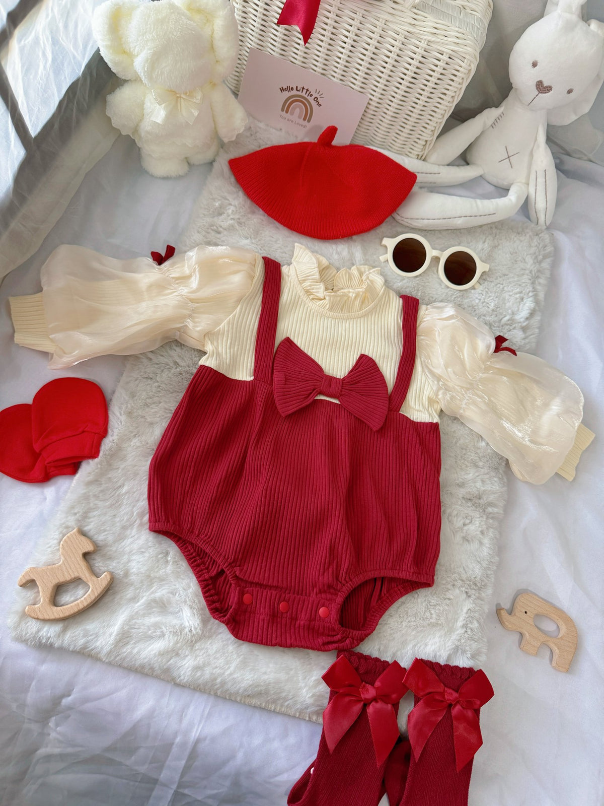 Red Riding Hood baby outfit flat lay – red romper with puff sleeves, bows and red beret
