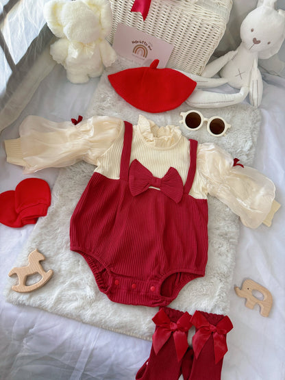 Red Riding Hood baby outfit flat lay – red romper with puff sleeves, bows and red beret