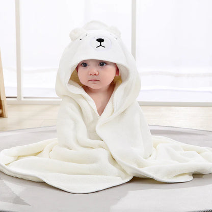 Baby wrapped in a white hooded bath towel with bear ears and embroidered face.