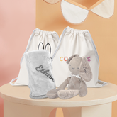 Grey Bunny Plushie displaying next to a grey fleece blanket, both with name embroidered.