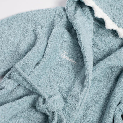 a blue bathrobe with a white embroidered name